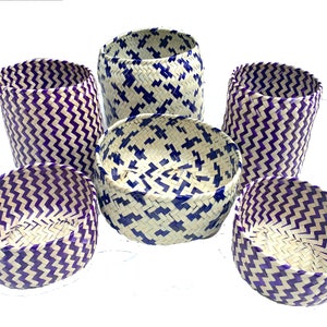 May include: Set of six woven baskets with a white and purple chevron pattern. The baskets are made from natural materials and have a rustic, handmade look.