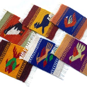 May include: A collection of six colorful, woven coasters with fringed edges. Each coaster features a unique bird or animal design in vibrant hues of red, yellow, blue, and purple. The coasters are approximately 4 inches by 5 inches.