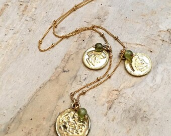 May include: Gold chain necklace with three gold coin pendants and green beads. Each coin features a detailed design.