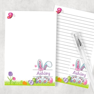 May include: Personalized stationery featuring a bunny rabbit with pink ears and a bow, surrounded by Easter eggs and flowers. The name "Ashley" is printed on the stationery.