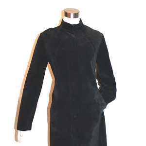 May include: A black long-sleeved mock neck jacket with a zipper closure and pockets.