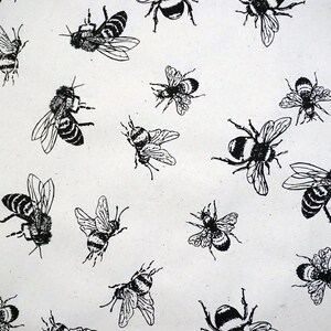 May include: A white background with a repeating pattern of black bees. The bees are drawn in a simple, stylized manner.