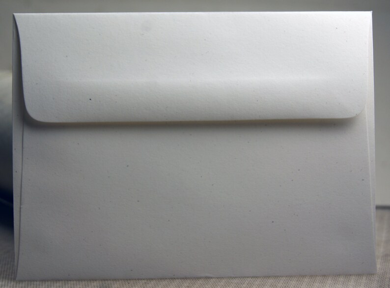 May include: A white envelope with a slightly textured surface.