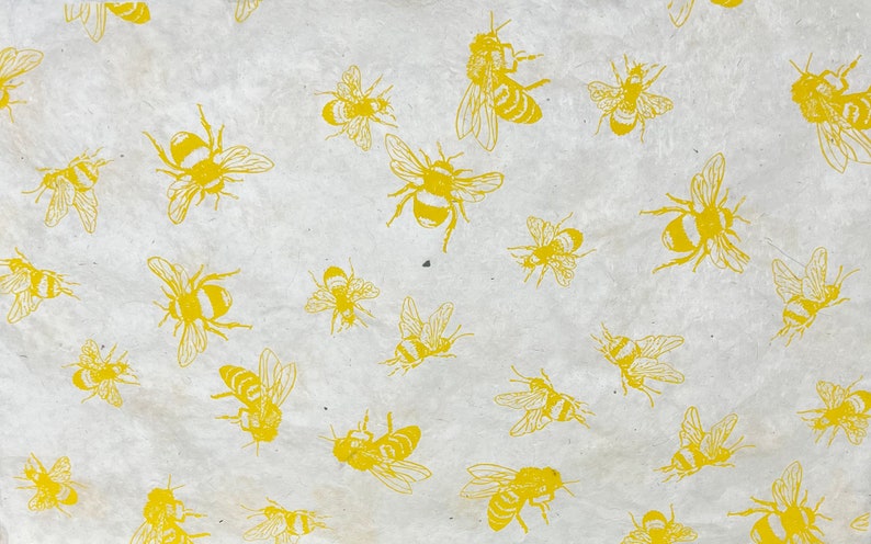 May include: A white background with a repeating pattern of yellow bees. The bees are drawn in a simple, stylized manner.