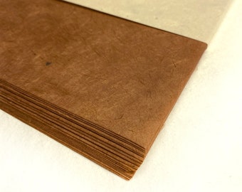 May include: A stack of brown paper sheets with a label that reads "Little Paper Flower - Hemlock" and a logo with the word "Earth".
