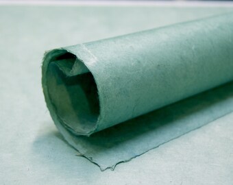 May include: A roll of light green paper with a textured surface.
