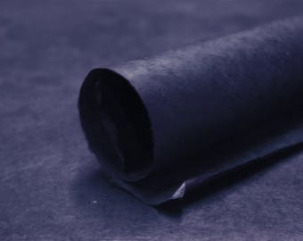 May include: A roll of dark blue paper, the paper is textured and has a slightly rough surface.