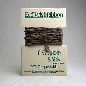 May include: A spool of dark brown EcoTwist Ribbon wrapped around a cream-colored paper card. The card features the text EcoTwist Ribbon, 1 inch Sequoia, 8 Yds., Made in Nepal, and 100% Compostable. The ribbon has a textured, twisted appearance.