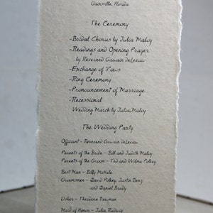 May include: A wedding ceremony program with the names Jill Maloy and Daniel Polkey, the date of the wedding, and the names of the wedding party members.