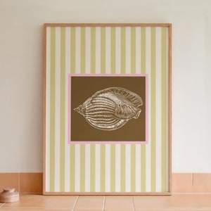 a green and white striped poster has a brown square with a pink border. In the square is a vintage white conch seashell image. The print is minimalist, beachy, with an east coast aesthetic. Great for bedroom or bathroom decor.
