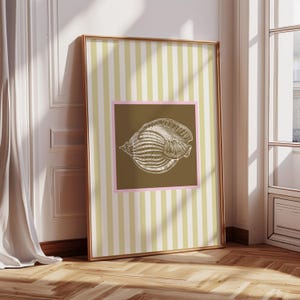 a green and white striped poster has a brown square with a pink border. In the square is a vintage white conch seashell image. The print is minimalist, beachy, with an east coast aesthetic. Great for bedroom or bathroom decor.