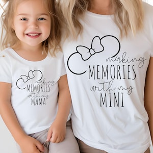 K&ouml;nnte beinhalten: Eine Mutter und ihre Tochter tragen wei&szlig;e T-Shirts mit schwarzem Text und einer Mickey-Maus-Silhouette. Das Shirt der Mutter lautet "Making Memories with my Mini" und das Shirt der Tochter lautet "Making Memories with my Mama".