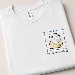 May include: A white crew neck t-shirt featuring a pixel art graphic on the chest. The design shows an envelope with a document inside, a small yellow tag labeled FYI, and a blue selection box. Below the graphic is the text per_my_last_email.msg.