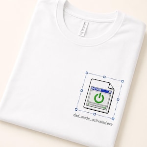 May include: A white t-shirt featuring a graphic of a computer window with a power button icon and the text DAD MODE and SYSTEM ACTIVATED. Below the window, the text dad_mode_activated.exe is printed in a pixelated font style.