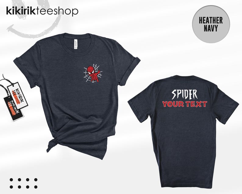 May include: A heather navy short-sleeve t-shirt featuring a small red spider-themed character graphic on the front left chest and the text "SPIDER YOUR TEXT" printed in white and red on the back. The shirt includes a branded tag attached.