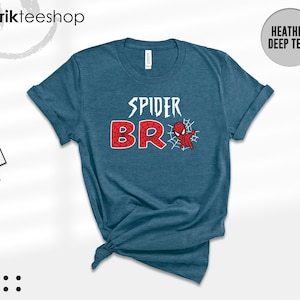 May include: A heather deep teal short-sleeve t-shirt featuring the white text SPIDER above the red text BRO, with a small red and blue spider-themed character graphic and a white spiderweb design integrated into the letter O.