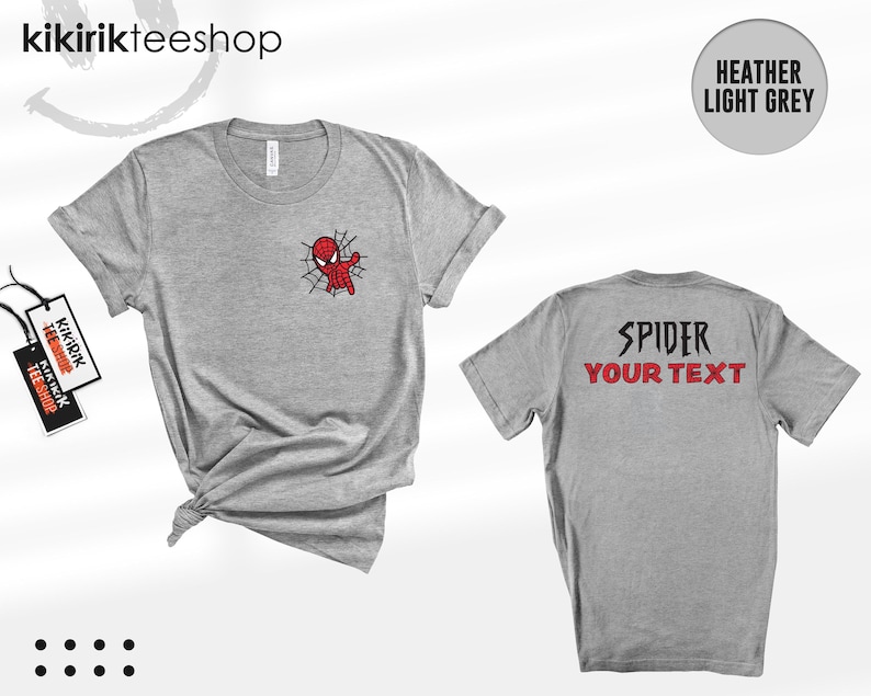 May include: A heather light grey short-sleeve t-shirt featuring a small Spider-Man graphic on the front left chest. The back of the shirt displays the text SPIDER in black and YOUR TEXT in red. The shirt is shown from both front and back views.