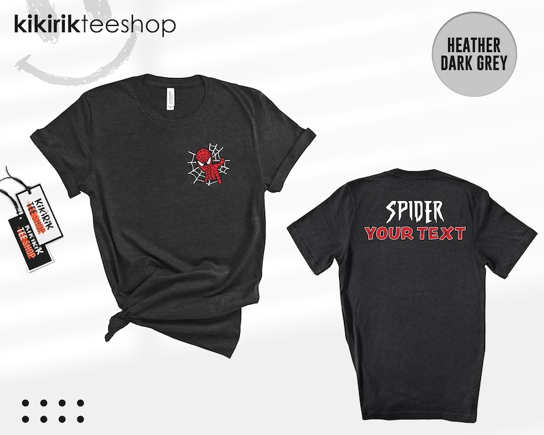 May include: A heather dark grey short-sleeve t-shirt featuring a small red spider-themed character graphic on the front left chest and the text SPIDER YOUR TEXT in white and red on the back. The shirt includes a branded tag attached to the side.