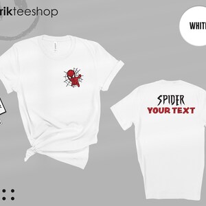 May include: A white short-sleeve t-shirt featuring a small red and black spider-themed character graphic on the front left chest. The back of the shirt displays the black text SPIDER and the red text YOUR TEXT in a bold, stylized font.