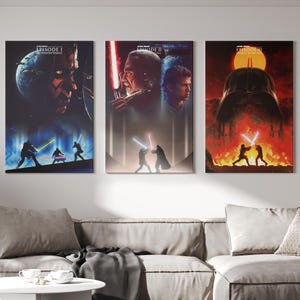 May include: Three Star Wars film posters. The posters depict characters and scenes from the films, including Darth Maul, Darth Vader, and lightsaber battles. The posters are displayed on a white wall above a grey sofa.