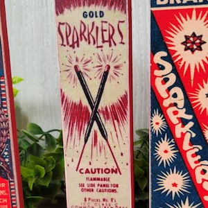 May include: Vintage red, white, and blue Easy Lite Gold Sparkler box with the text "CAUTION FLAMMABLE" and "MANUFACTURED BY ELKTON SPARKLER CO. INC. NORTH EAST MARYLAND".