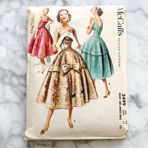 50s McCalls 3499. 33 bust. square neck fit flare cocktail party dress with bow. basque waist bodice low back. 1950s vintage sewing pattern