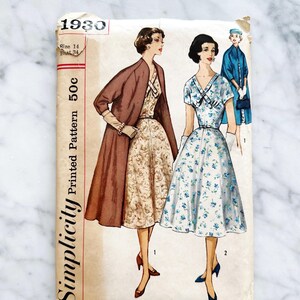 May include: Vintage Simplicity sewing pattern number 1930 for a dress. The pattern is for size 14, bust 34, and costs 50 cents. The pattern shows two women wearing dresses, one in a floral print and the other in a solid brown colour.