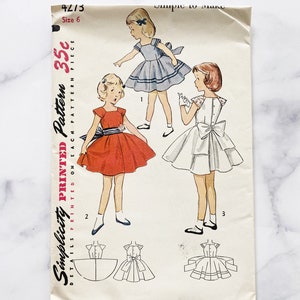50s Simplicity 4273 girls size 6 uncut ff. girls ruffle cap sleeve back bow sash tie fit and flare dress. 1950s Vintage Sewing Pattern.