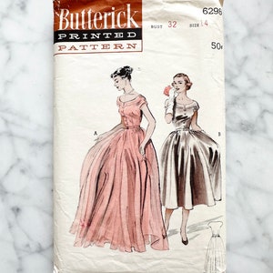 May include: Vintage sewing pattern for a dress, Butterick Printed Pattern 6296, size 14, bust 32. The pattern shows two illustrations of women wearing the dress, one in pink and one in gray. The pattern is printed on a white background.