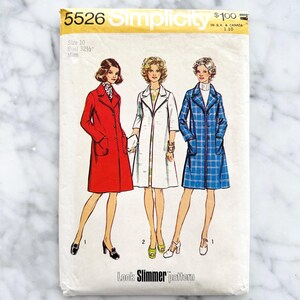 May include: Vintage Simplicity sewing pattern 5526 featuring illustrations of three coat designs. The pattern includes a red coat, a white coat, and a blue plaid coat. The pattern is size 10, bust 32 1/2 inches, and is labeled "Look Slimmer pattern."