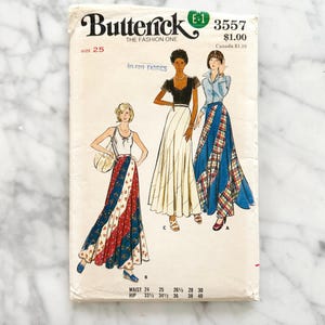 May include: Vintage Butterick sewing pattern, size 25, featuring illustrations of three different skirt designs. The pattern includes waist and hip measurements. The cover has the text "Butterick THE FASHION ONE" and the price.