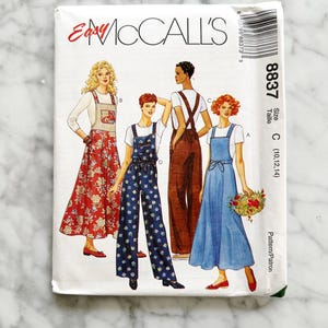 May include: A sewing pattern for a jumpsuit with three different styles. The pattern is for sizes 10, 12, and 14. The pattern is from McCall's and is called "Easy McCall's" and the pattern number is 8837.