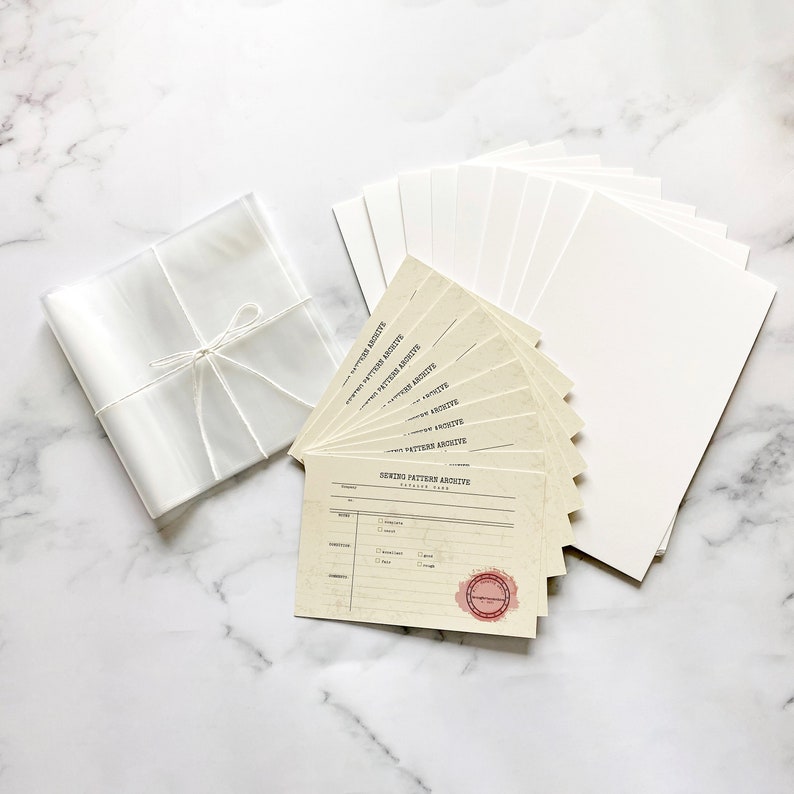 May include: A set of ten blank cards with the text "Sewing Pattern Archive" printed on them. The cards are packaged in a clear plastic bag with a white ribbon.