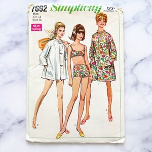 May include: Vintage Simplicity sewing pattern 7692 for a miss size 14, bust 36. The pattern includes three outfits: a white jacket with a floral print, a floral print top and shorts, and a floral print dress. The pattern is labelled "New Sizing".