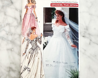 Butterick 3513 – Sizes 6-8-10. 1980s off shoulder bridal gown with lace sleeves, rosettes and train. Vintage sewing pattern.