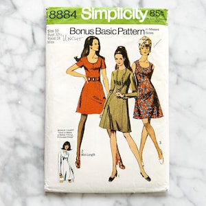 May include: Vintage Simplicity sewing pattern 8884, featuring illustrations of three dresses. The pattern includes a bonus chart for a princess dress and is uncut. The front of the pattern is green and white with the price of 85p.