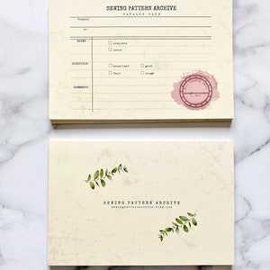 May include: A cream-colored card with a black and white text that reads "Sewing Pattern Archive Catalog Card". The card has a checklist for "Notes", "Condition", and "Comments". There is a pink stamp that reads "Sewing Pattern Archive Est. 2021".