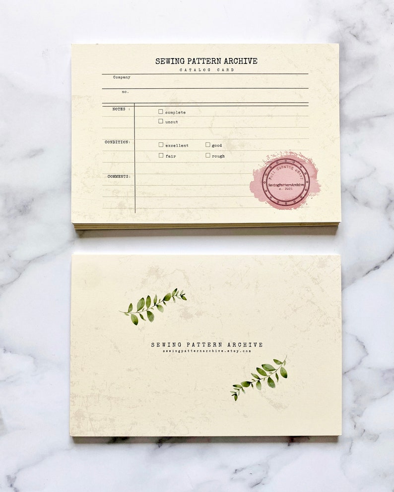 May include: A cream-colored card with a black and white text that reads "Sewing Pattern Archive Catalog Card". The card has a checklist for "Notes", "Condition", and "Comments". There is a pink stamp that reads "Sewing Pattern Archive Est. 2021".