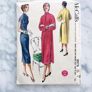 May include: Vintage McCall's sewing pattern for a dress and unlined coat. The pattern is for size 12, bust 30, and costs 75 pence. The pattern features three women wearing the garments. The dress is blue, the coat is red, and the third garment is yellow.