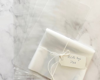 May include: A stack of clear plastic bags with a tag that reads "McCall's Bags 20pcs" tied with twine.