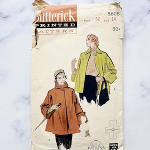 May include: Vintage sewing pattern for a women's coat. The pattern is for Butterick pattern number 5608, size 14, bust 32. The pattern is for a coat with a collar and long sleeves. The pattern is printed on paper and has a vintage look.
