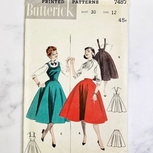 May include: Vintage sewing pattern for a skirt with a 30 inch bust size. The pattern is from Butterick and is number 7487. The pattern shows three different styles of skirts, one in red, one in teal, and one in black.