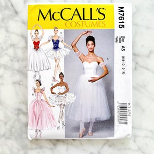 May include: A McCall's Costumes sewing pattern, M7615, featuring illustrations of ballet costumes. The pattern includes various designs, with a white and yellow cover. Size A5, for sizes 6-8-10-12-14.