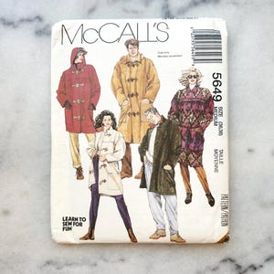 May include: McCall's sewing pattern number 5649 for a coat. The pattern is for sizes 36 and 38, and is labeled as 'medium'. The pattern includes instructions for making a coat with a toggle closure. The pattern is illustrated with four people wearing different versions of the coat.