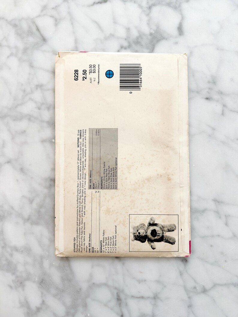 May include: A sewing pattern for a stuffed Grumpy Bear toy. The pattern includes instructions, fiberfill, and craft glue. The pattern is for a bear that is approximately 17 inches tall. The pattern is printed on white paper with black text and a picture of the finished bear.
