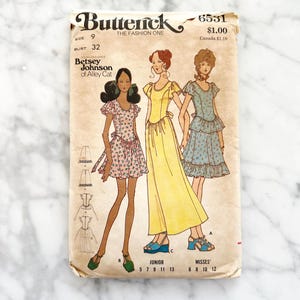 May include: Vintage sewing pattern envelope for a dress, featuring three women wearing different styles of dresses. The pattern is by Butterick, designed by Betsey Johnson of Alley Cat, and is number 6531. The pattern is for sizes 9-13 junior and 6-12 misses.