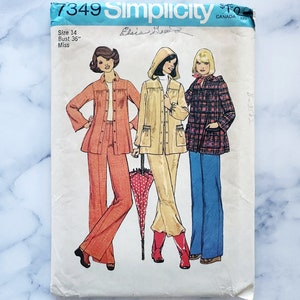 May include: Simplicity sewing pattern number 7349 for a miss size 14 with a 91.4 cm bust. The pattern includes three different outfits: a long-sleeved jacket and trousers, a hooded jacket and trousers, and a plaid jacket and jeans.
