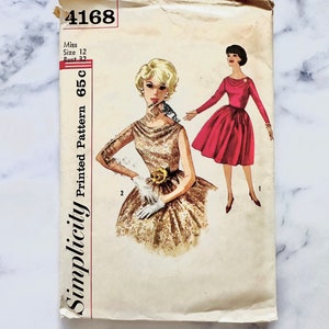 May include: Vintage Simplicity sewing pattern number 4168 for a dress. The pattern is for a miss size 12 with a bust size of 32. The pattern shows two women wearing dresses, one in a gold and one in a red dress.