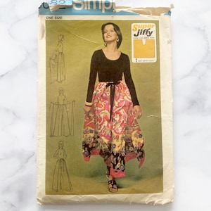 May include: Vintage sewing pattern for a skirt and pants. The pattern is for one size and is called "Super Jiffy" easy cut-easy sew. The pattern shows a woman wearing a black top and a colorful skirt with pants underneath.