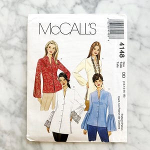 May include: A McCall's sewing pattern envelope showing four blouse designs. The envelope is white with the McCall's logo and pattern number 4148. The size is DD (12-14-16-18).